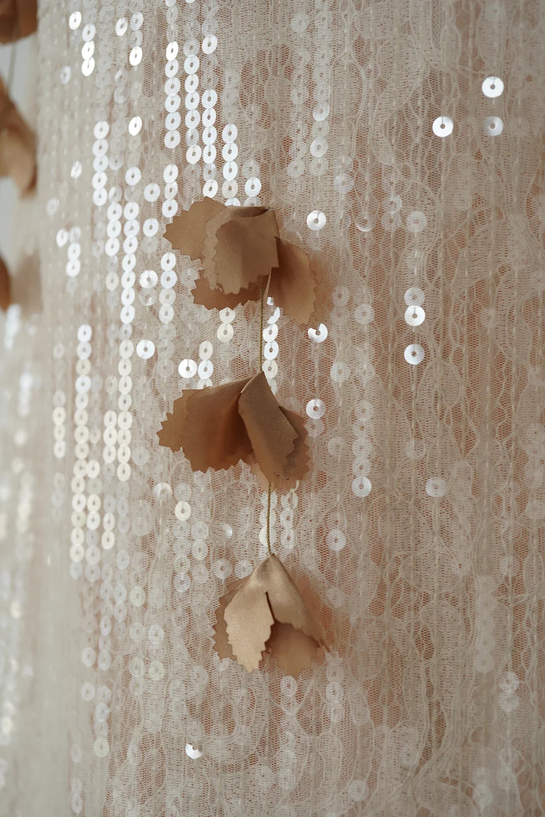 Sequin and floral applique fabric detail on ivory lace maxi dress