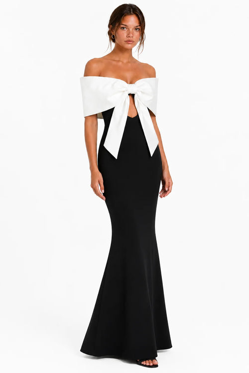 Angled front view of black off-shoulder bow bandage maxi dress