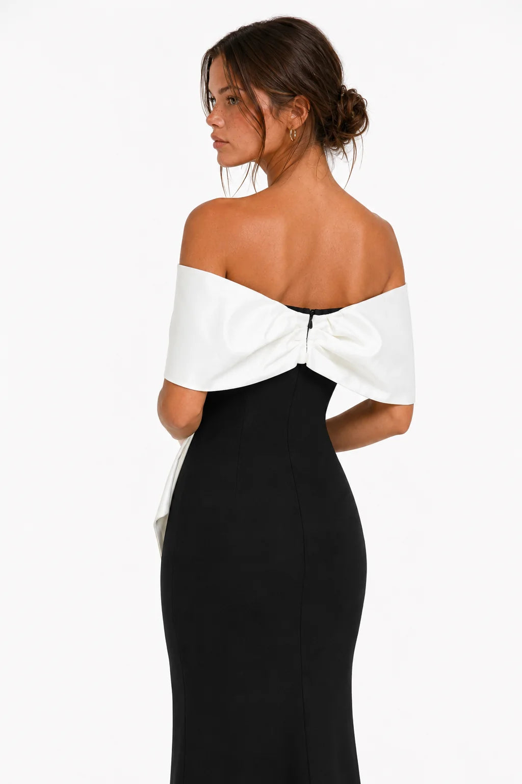 Back three-quarter view of black off-shoulder bow bandage maxi dress