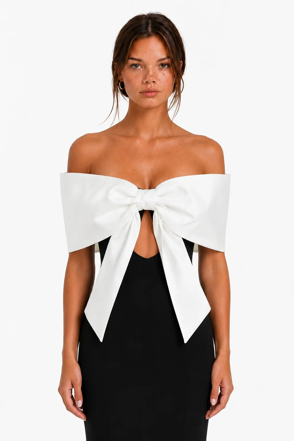 Close-up detail of the oversized white bow on black maxi dress